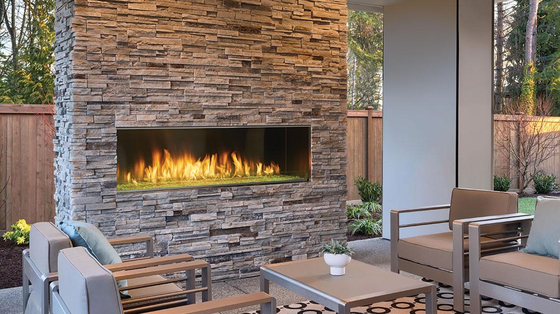 Majestic Lanai 60" Outdoor Linear Gas Fireplace, single-sided, in stacked-stone hearth wall